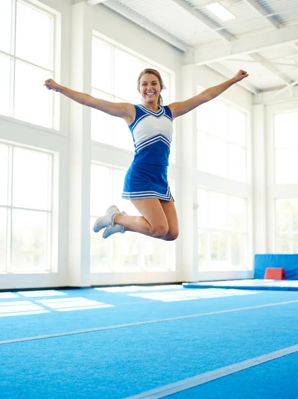 A cheerleader mid jump